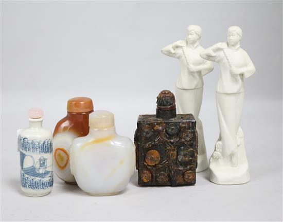 Four snuff bottles, one blue and white, two quartz, one reconstituted amber and two biscuit porcelain